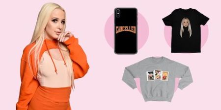 tana in an orange outfit along side her merch 